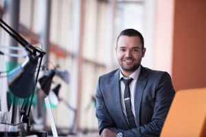 happy young business man portrait in bright modern office indoor
